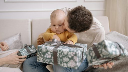 a father kissing his baby on the cheek