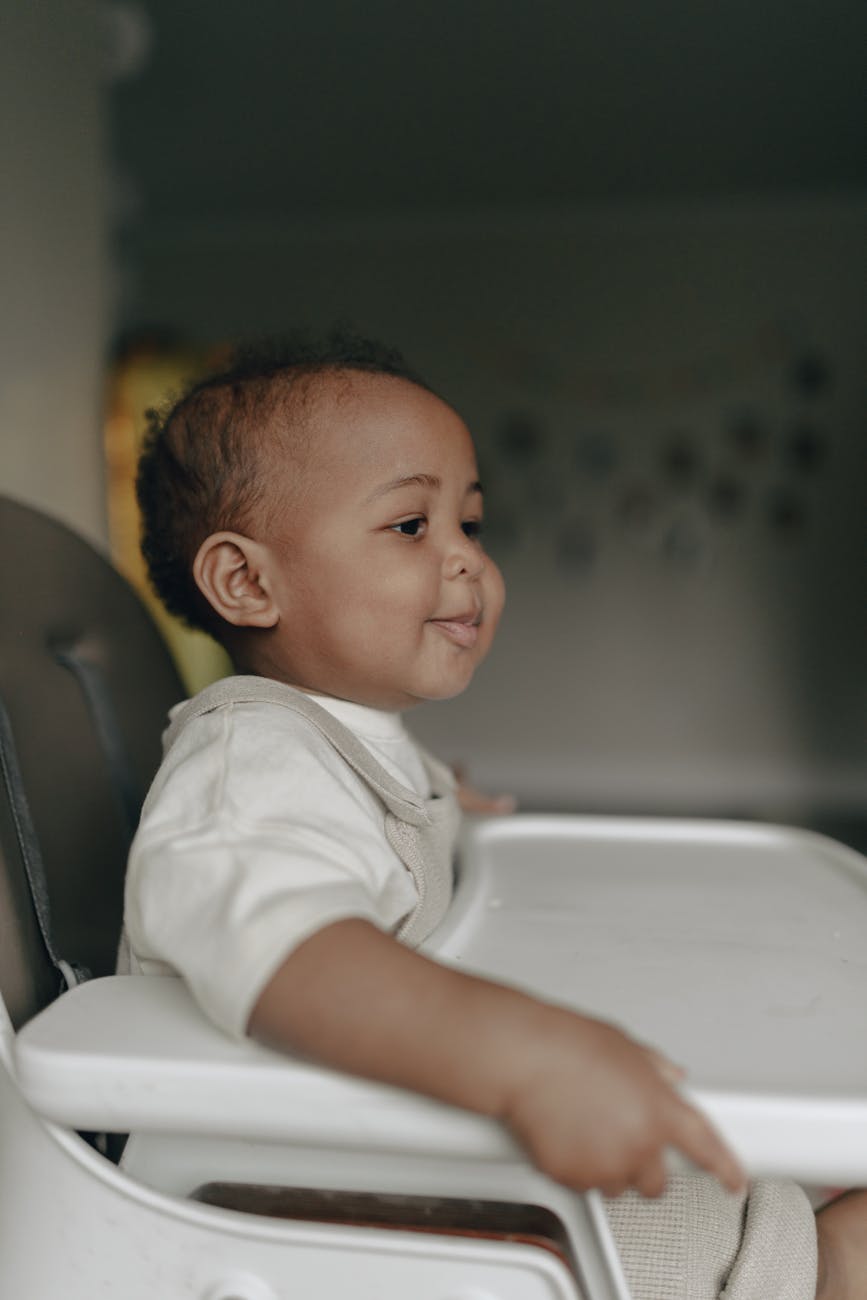 baby sitting in a high baby chair