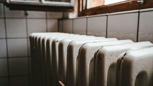 white radiator heater beside brown wooden window