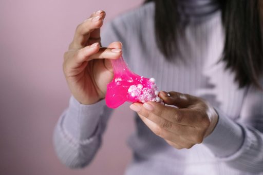 Close-Up Shot of a Person Holding a Pink Slime