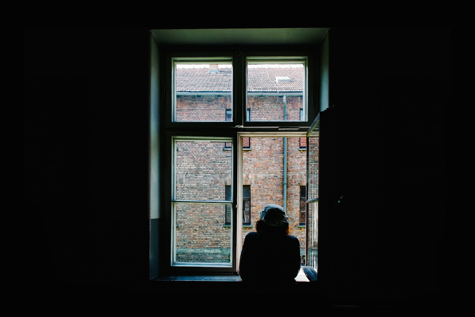 person standing in front of open window