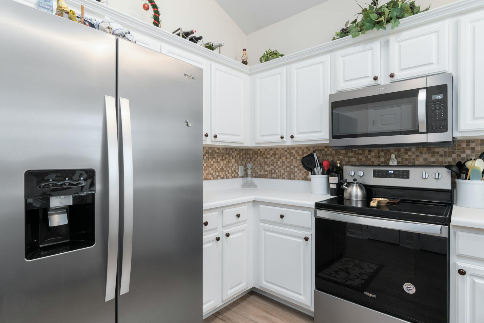 Contemporary kitchen interior featuring modern stainless steel fridge and microwave.