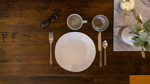 white ceramic plate on brown wooden table