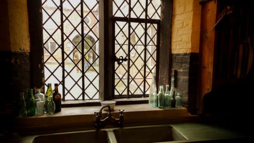 white ceramic sink near window