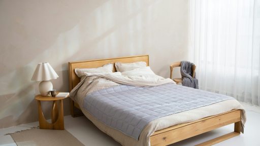 a bed sitting in a bedroom next to a window