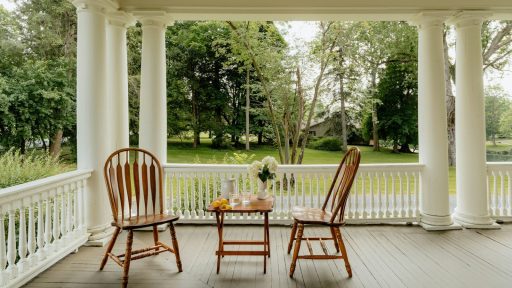 Two chairs and a table on a porch