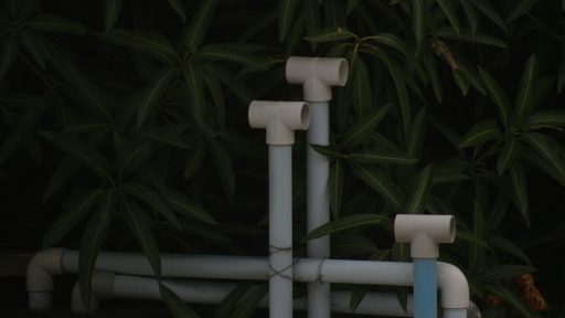 A close up of pipes and pipes in front of a tree