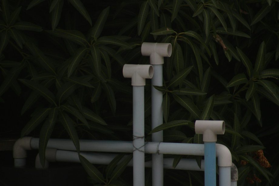 A close up of pipes and pipes in front of a tree