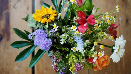 assorted-color flowers on brown wood