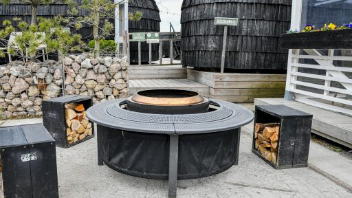 Modern outdoor fire pit with seating and firewood