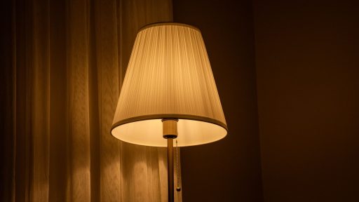 Softly glowing table lamp in a cozy room creates a warm and inviting atmosphere.