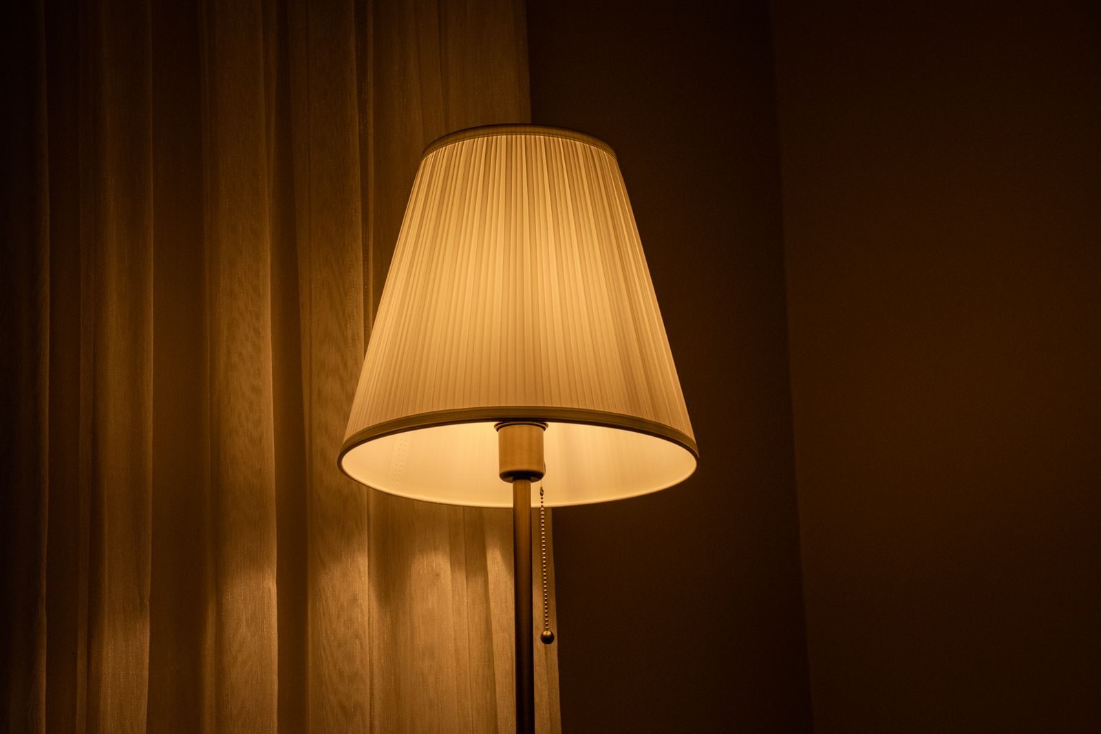 Softly glowing table lamp in a cozy room creates a warm and inviting atmosphere.